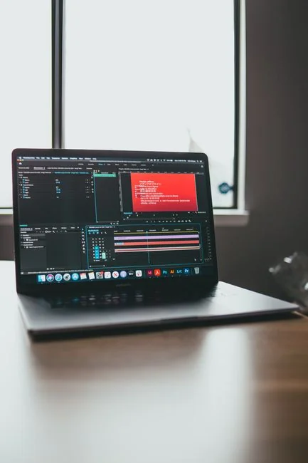 Stylish and efficient workspace with multiple monitors, laptop, and smartphone, showcasing a web design project.